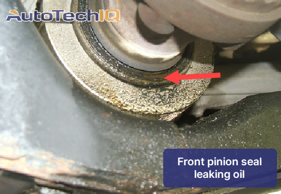 Detailed view of a front pinion seal exhibiting oil leakage, indicating potential maintenance need